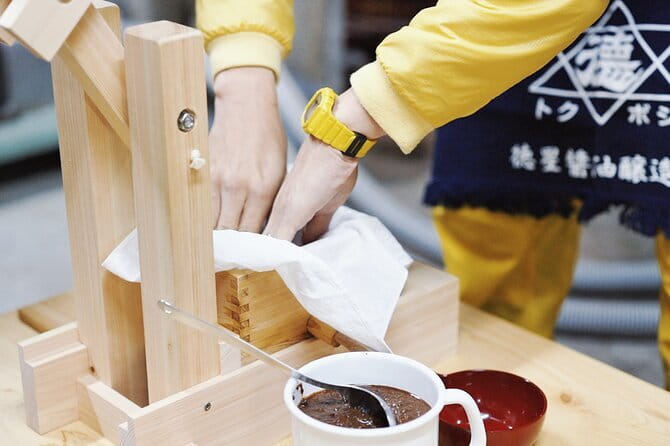 Make Your Own Soy Sauce in Japan’s Old Capital Asuka Nara - Pressing moromi by hand with a wooden press
